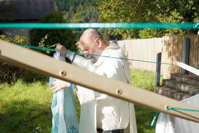 Fr Giles hanging sheets to dry at the previous women’s retreat accommodation. 