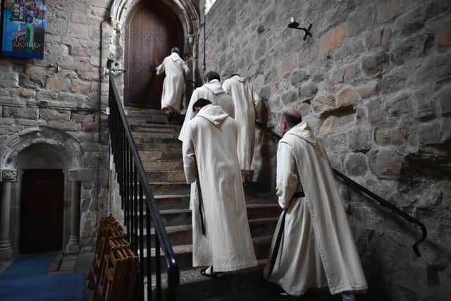 There are 16 monks who reside at Pluscarden Abbey.