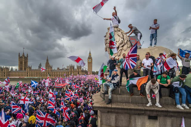 Protesters wave flags during the Unite The Kingdom rally, organised by far-right activist Tommy Robinson, in London earlier this month (Picture: Christopher Furlong)