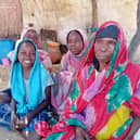 Naima and her daughters sit in the shade of the temporary shelter that is their home in Zabout camp.