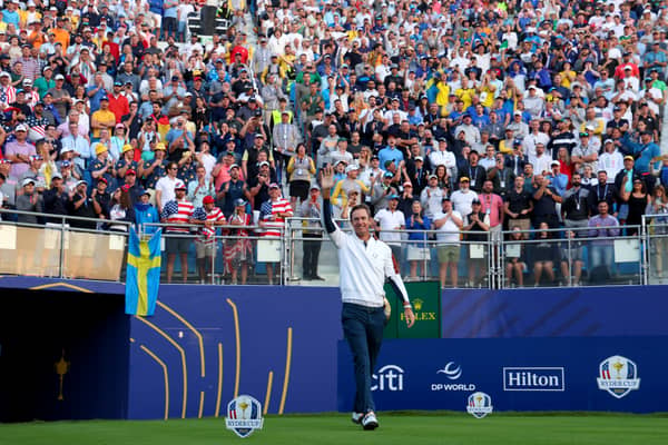 Nicolas Colsaerts, one of Luke Donald's vice captains, engages with the crowd on the first tee during the 2023 Ryder Cup at Marco Simone Golf Club in Rome