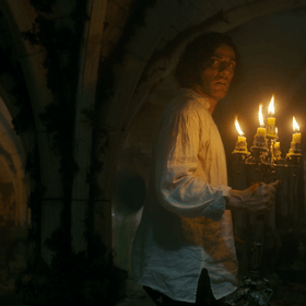 Oscar Isaac as Victor Frankenstein exploring what appears to be Glasgow Cathedral in a still from Guillermo del Toro's Frankenstein. 