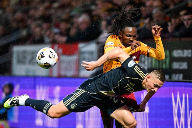 Aberdeen's Kristers Tobers is challenged by Motherwell's Regan Charles-Cook during the match at Fir Park on Saturday. (Photo by Rob Casey / SNS Group)