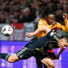 Aberdeen's Kristers Tobers is challenged by Motherwell's Regan Charles-Cook during the match at Fir Park on Saturday. (Photo by Rob Casey / SNS Group)