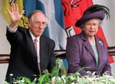 Donald Dewar, seen with the late Queen Elizabeth, waves while watching parades held to mark the opening of the Scottish Parliament on July 1, 1999 (Picture: Roger Donovan)