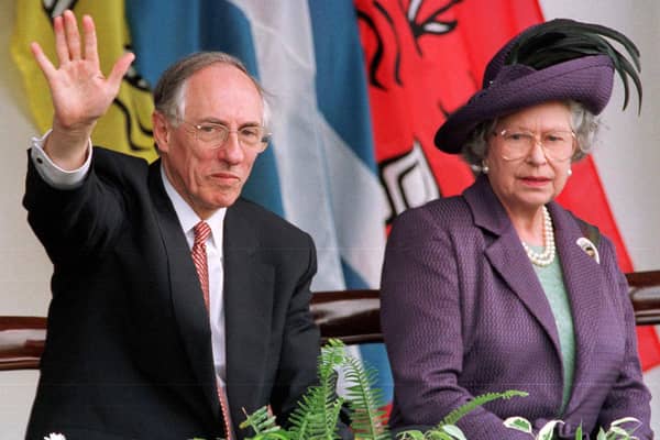 Donald Dewar, seen with the late Queen Elizabeth, waves while watching parades held to mark the opening of the Scottish Parliament on July 1, 1999 (Picture: Roger Donovan)