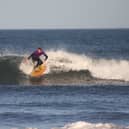 Tim Christopherson rides a wave at Belhaven Bay near Dunbar