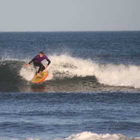 Tim Christopherson rides a wave at Belhaven Bay near Dunbar