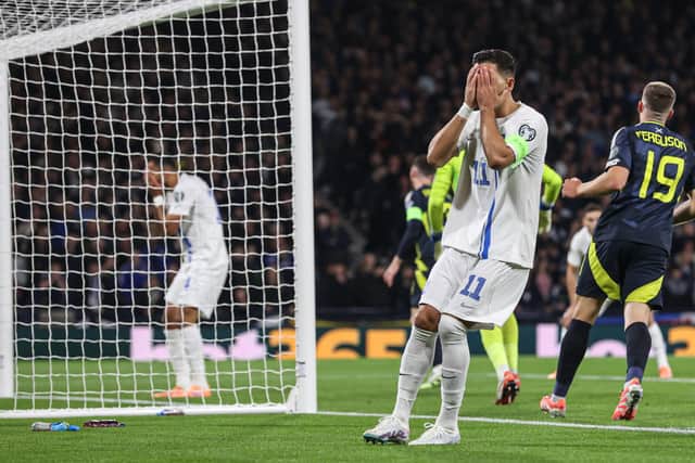 Greece's Anastasios Bakasetas looks dejected as Vangelis Pavlidis misses a good chance to score.