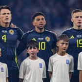 Scotland's Scott McTominay, Che Adams and Lewis Ferguson (L-R) sing the national anthem prior to the 3-1 World Cup qualifying win over Greece at Hampden Park. Cr: SNS Group.