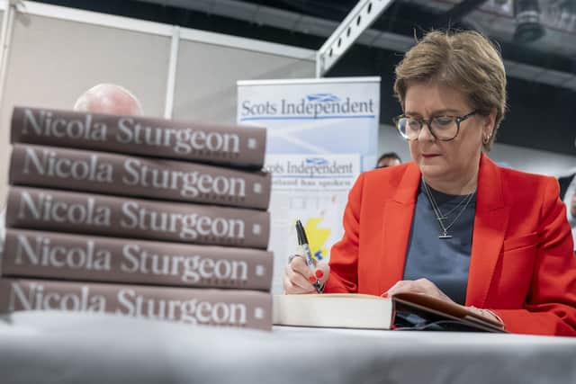 Nicola Sturgeon MSP signs copies of her book at the SNP conference.