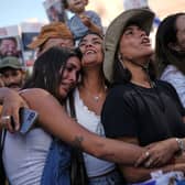 People react as they gather to watch a live broadcast of Israeli hostages released from Gaza at a plaza known as hostages square in Tel Aviv.