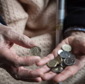 An elderly person looks at cash at home. Winter Fuel Payments for 2025/26 will start arriving in November, with most paid by December (Photo: Matt Cardy/Getty Images)