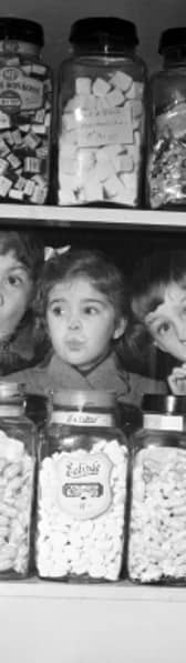 Children pressing their noses against the window of 'Mary's' sweet shop, Anniesland, Glasgow, 1954