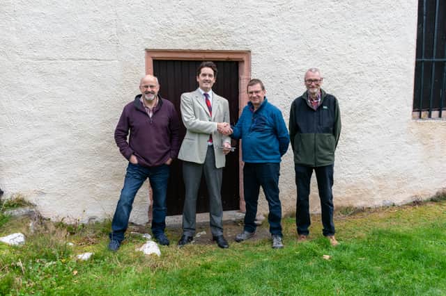 The giant key to Wardlaw Mausoleum is handed over. Pictured (left to right) Erik Lundberg, trustee of Aird Community
Trust; Simon Fraser, 16th Lord Lovat; George Hogg, chair of Aird Community Trust and Jim Murray, trustee of Aird Community Trust.
