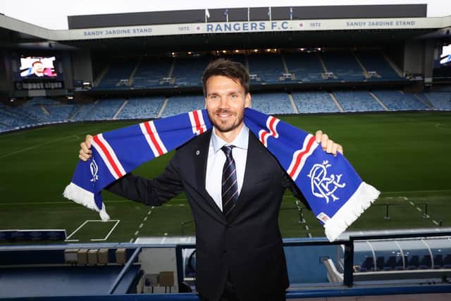 New Rangers head coach Danny Rohl holds the scarf aloft at Ibrox.
