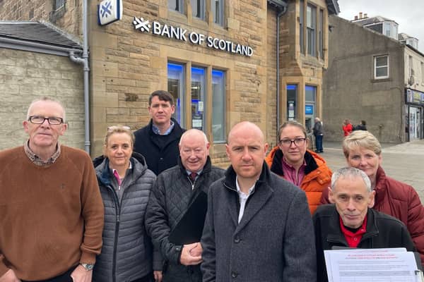 Frank McNally, centre right, outside the Bank of Scotland branch which will close in Bellshill