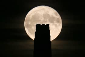 A full beaver moon rising behind St Michael's Tower on Glastonbury Tor in 2017