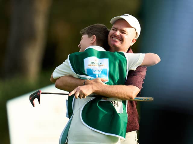James Morrison hugs his son Finley after winning the Rolex Grand Final Supported By The R&A on day four of the Rolex Grand Final supported by The R&A at Club de Golf Alcanada in Alcudia