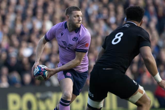 Ardie Savea keeps a close eye on Finn Russell during a Scotland v New Zealand match in 2022.