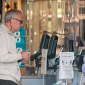 A customer at a Co-Op store. The retailer will open or refurbish 50 stores by Christmas, investing over £200 million in its UK estate (Photo: JUSTIN TALLIS/AFP via Getty Images)