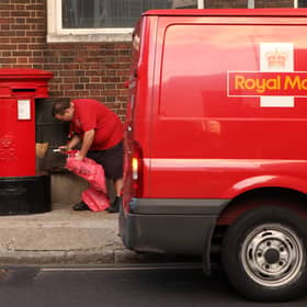 A Royal Mail employee empties a post box in London. Royal Mail has delayed its plans to scrap Saturday second-class letter deliveries until early 2026 (Photo: Oli Scarff/Getty Images)