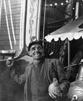 A miner tries his luck at the coconut shy at the Good Friday Fair in Conisbrough, South Yorkshire, in 1955