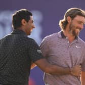 Aaron Rai and Tommy Fleetwood embrace on the 18th green on day one of the DP World Tour Championship  at Jumeirah Golf Estates in Dubai 