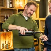 Dougal Gunn Sharp, Founder and Head Brewer at Innis & Gunn, and Jamie Allsopp, Director at Allsopp's and a direct descendent of the brewer's founders, at Innis & Gunn's Brewery in Perth. They opened a bottle of 150 year-old Allsopp's Arctic Ale for the first time to mark the 150th anniversary of the 1875 arctic expedition it was brewed for. 