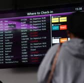 A person views a check-in display at Edinburgh Airport