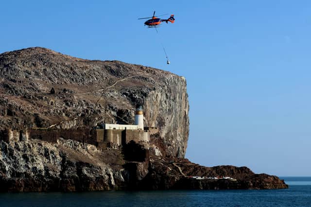 A helicopter airlifting materials to Bass Rock