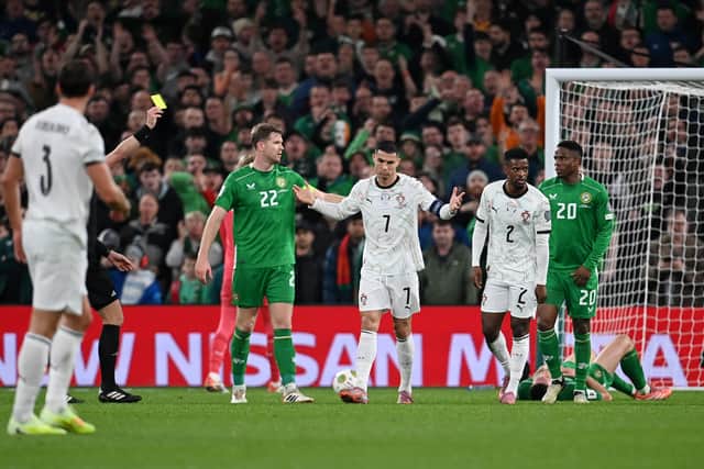 Cristiano Ronaldo is shown a red card for an elbow on Republic of Ireland's Dara O'Shea.