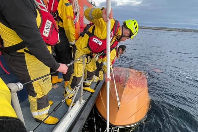 Rescue mission after man found clinging to capsized boat 'by his ...