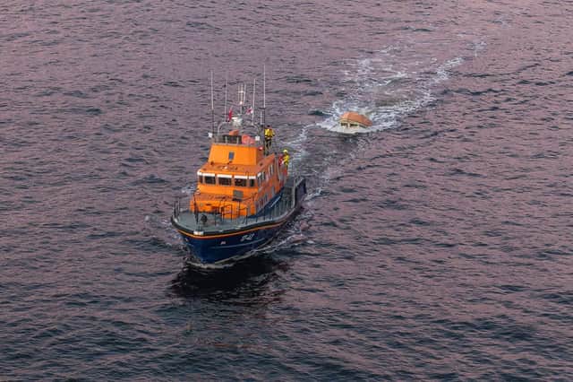 Rescue mission after man found clinging to capsized boat 'by his ...