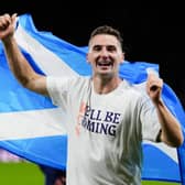 Wondergoal-scorer Kenny McLean waves a non-partisan Saltire as he celebrates Scotland's qualification for the World Cup (Picture:  Andrew Milligan)