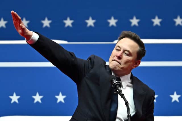 Elon Musk makes a gesture that was likened to a Nazi salute earlier this year (Picture: Angela Weiss)