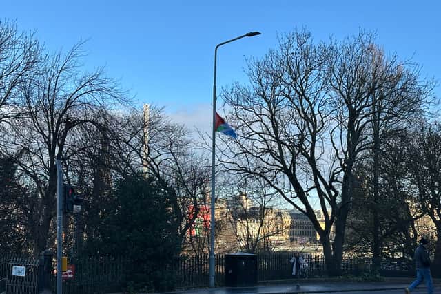 A 'solidarity Palestine Saltire' flag attached to a lamppost at the top of The Mound in Edinburgh