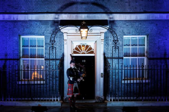 A piper welcomes guests to the first St Andrews Day event at No.10 in a decade