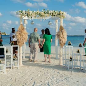 Surrounded by the Nova wedding party my wife and I renewed our vows on the white sands of Vakarufalhi.