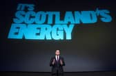 John Swinney  stand's beneath a slogan reminiscent of the SNP's 'It's Scotland's oil' campaign (Picture: Jane Barlow)