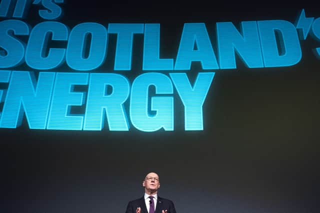 John Swinney  stand's beneath a slogan reminiscent of the SNP's 'It's Scotland's oil' campaign (Picture: Jane Barlow)