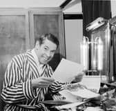 Scottish entertainer Stanley Baxter reads some of his telegrams in his dressing rooms backstage at the Kings Theatre in Edinburgh in April 1966