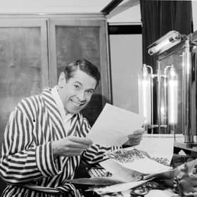 Scottish entertainer Stanley Baxter reads some of his telegrams in his dressing rooms backstage at the Kings Theatre in Edinburgh in April 1966
