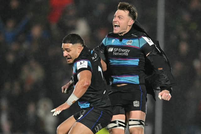 Glasgow Warriors' centre Sione Tuipulotu (L) and No 8 Jack Dempsey celebrate after the win over Toulouse in the European Champions Cup Pool 1 match at Scotstoun Stadium.