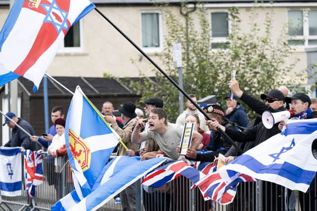 People take part in a protest outside the Cladhan Hotel in Falkirk in September