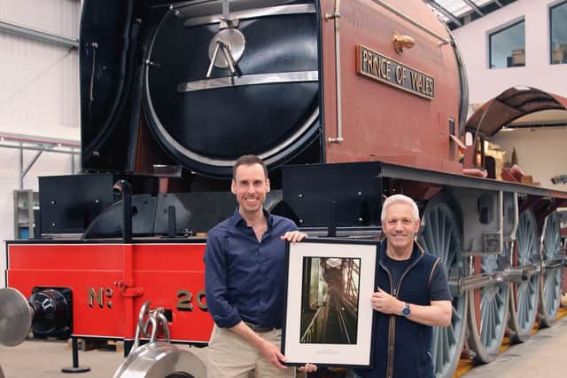 John Brownlie and A1 Steam Locomotive Trust chair Steve Davis with the Over the Forth print beside P2 Prince of Wales under construction in Darlington