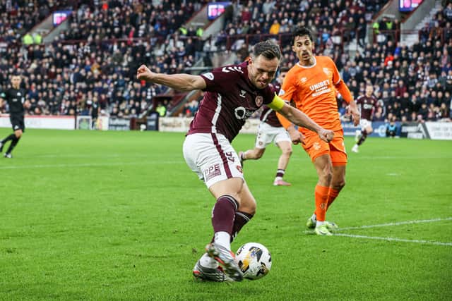Lawrence Shankland drills the ball home for Hearts' second goal against Rangers - although goalkeeper Jack Butland should have done better.