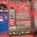 The entrance to the monument has been doused in red paint and a slogan saying 'support the hunger strikers'  has been painted on the wall 
