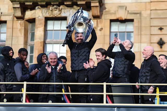 St Mirren manager Stephen Robinson lifts the Premier Sports Cup.
