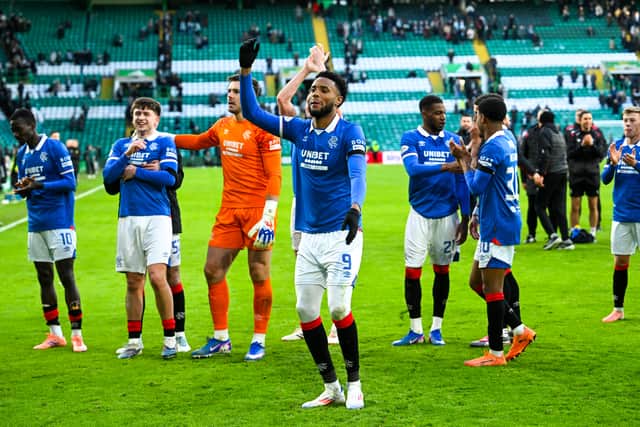 Rangers striker Youssef Chermiti leads the celebrations at Celtic Park.
